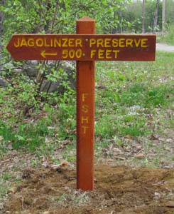 Sign marking start of preserve 250 feet from the road.